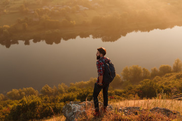 Bearded guy standing near river