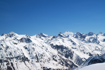 Fototapeta na wymiar Snow covered mountains with mount Elbrus at background