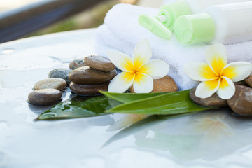 spa bottles and stones for massage treatment on background with copy space.