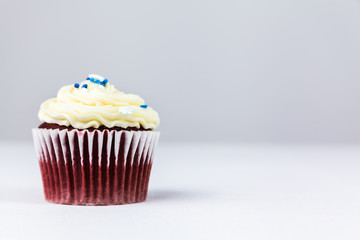 Red Velvet Cupcake With Cream Cheese Frosting and Sprinkles
