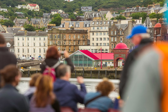 Ferry Tourists on a Looking Towards Oban Scotland
