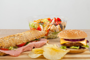 Sandwich, cheeseburger, salad and chips
