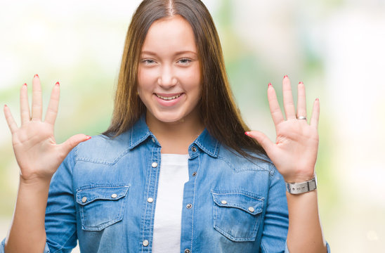 Young caucasian beautiful woman over isolated background showing and pointing up with fingers number ten while smiling confident and happy.