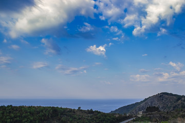 Cumulus clouds and fog over the sea and mountains. Soft focus and blurred background.