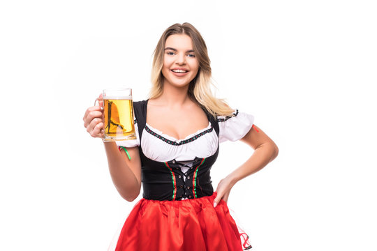 Happy smiling woman in dirndl dress holding Oktoberfest beer stein isolated on white background.