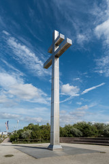 Fototapeta na wymiar The cross Croix de Lorraine on the coast at Juno Beach, commemorates the return of General de Gaulle to France. The Cross is at Courseulles-sur-Mer, Normandy, France
