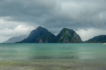 Landscape of Palawan, El Nido. Ocean and rock islands in background. Cloudy stormy sky after...