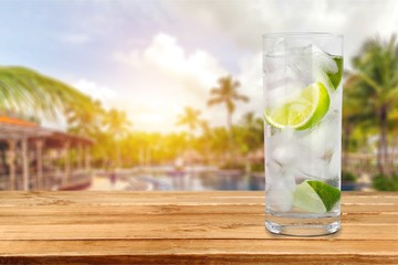 Glass of water  and lime on  background