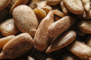Obraz premium Peeled, roasted and salted sunflower seeds. Macro close-up photography.