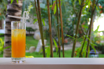 Glass of Juice on tropical background