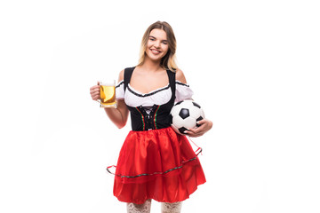 Young blonde woman wear in traditional dirndl with mug of beer and soccer ball isolated on white background