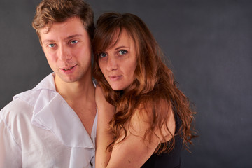 a couple in love stands on a dark background