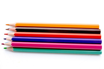 Close up of multicolored crayons on a white background