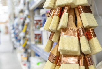Paint brushes with a copper base and yellow bristles.