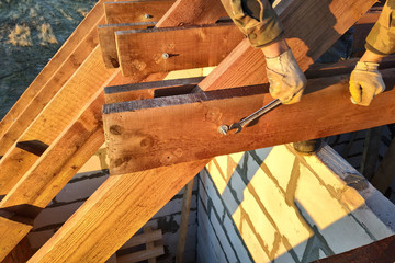 The worker twists the bar of the rack using a wrench