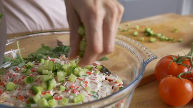 add cucumbers into salad bowl