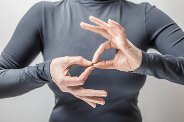 Woman learns sign language to talk. Hand gestures of people with hearing impairment.  - 245007684