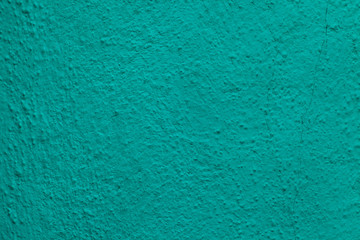 Emerald green painted stucco wall. Background texture.
