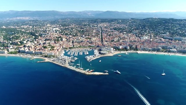 High altitude aerial shot from helicopter showing Cannes a city located on  French Riviera and host of annual Film Festival and known for its association with rich and famous 4k high resolution