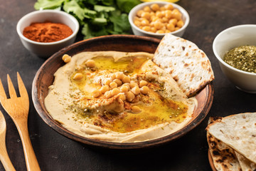 Classic Hummus with chickpeas, paprika, olive oil and oriental spices. Mediterranean popular snack of chickpeas and tahini pasta.