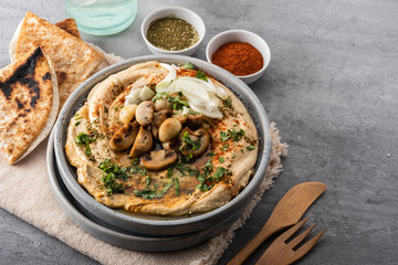Traditional Mediterranean hummus with mushrooms and onions. Classic Hummus with paprika, olive oil, onions, mushrooms and seasonings