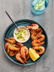 Shrimp glazed in soy sauce with green onion and lemon.