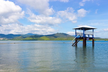 Empty wooden lifeguard tower or post on the sea on a tropical island in the area for diving and snorkeling, Philippines. Summer beach background with perfect landscape