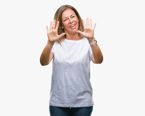 Obraz na płótnie Canvas Middle age senior hispanic woman over isolated background showing and pointing up with fingers number ten while smiling confident and happy.
