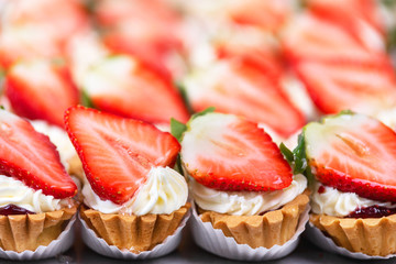 Delicious strawberries cheesecakes tartlets with fresh strawberries .