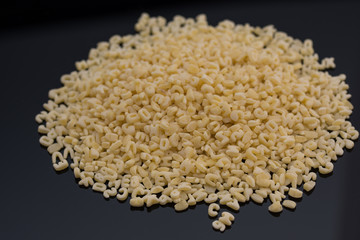 Alphabet pasta on black background