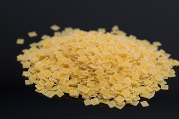 Uncooked small pasta on white background