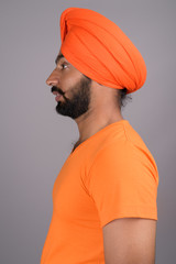 Indian Sikh man wearing turban and orange shirt