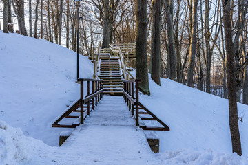 Snowy Photo of the Park on a Sunny Winter day - Wooden Footpath in the Middle of it, Concept of the Harmony and Travel