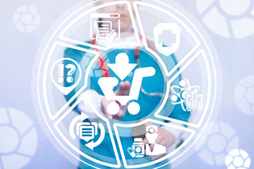 Young medical woman working on a virtual screen of the future and touches the icon: shopping cart. Drugstore. Pharmacy marketing concept. Medical procurement and buying.