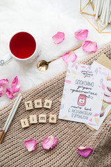 Cup of freshly brewed fruit and herbal tea, fresh raspberry, cookies, book, clothes. Photo for fashion, lifestyle and food blogs, content