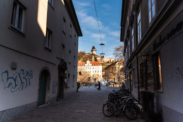 Street leading clock tower and square in center city Graz