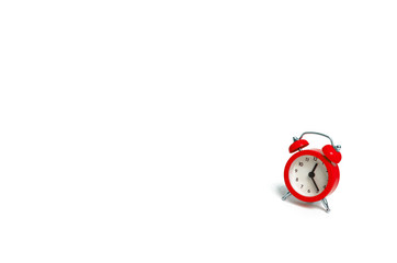 A red alarm clock on a white background. The concept of time and planning. The past, the future and the present. Minimalism. Free or business hours. Life expectancy. Abstraction of time.