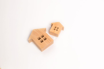 Two wooden houses on a white background. Concept of real estate, buying and selling. Rent. Statistical data. Minimalism. Investments, insurance and construction of housing and business.