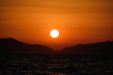 sunset at the sea against the background of mountains close up