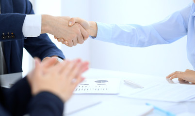 Group of business people or lawyers shaking hands finishing up a meeting , close-up. Success at negotiation and handshake concepts