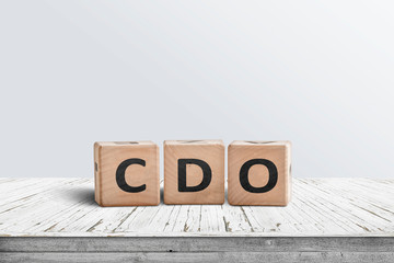 CDO sign collateralised debt obligations on a wooden desk
