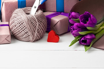 romantic gift boxes with flowers on white wooden background