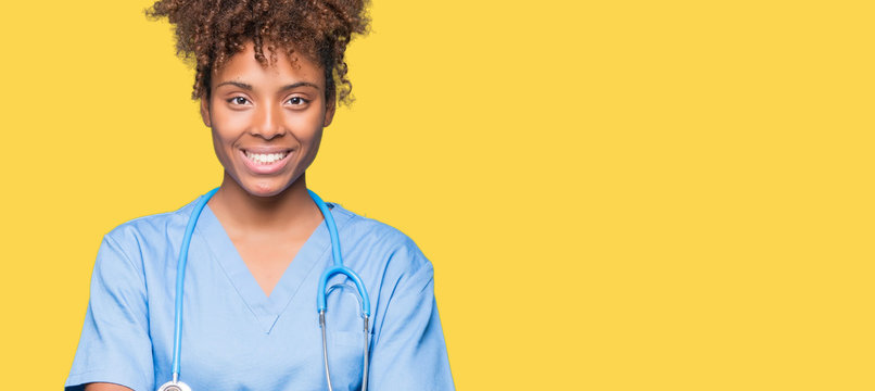 Young african american doctor woman over isolated background happy face smiling with crossed arms looking at the camera. Positive person.