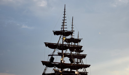 Masts of a pirate ship in the sunset