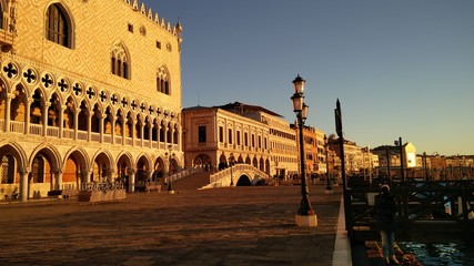 Fototapeta premium Venice Sunrise with nobody, Black Gondola and Golden Sun Light over the Grand Canal