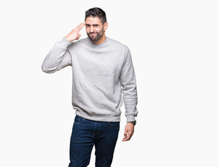 Young handsome man wearing sweatshirt over isolated background Shooting and killing oneself...