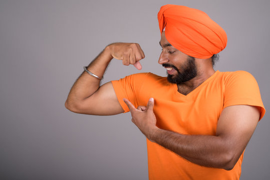 Indian Sikh Man Wearing Turban And Orange Shirt