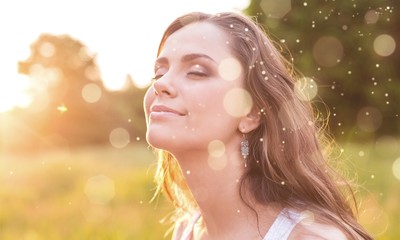 Young woman on field under sunset light