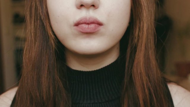 A young girl eats with a fork. Face close up. HD