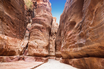 The road between the red rocks of the Siq gorge to the ancient city of Petra, Jordan